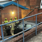 Car crashes through railings and hits Loughborough school building